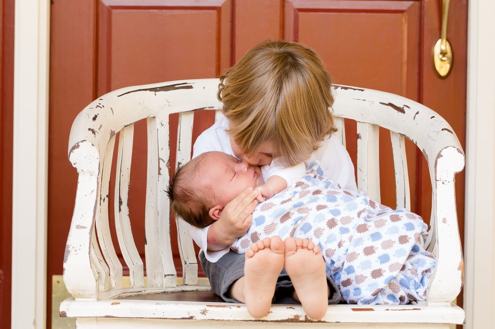 Parent and child holding hands, forming a heart shape, during an adoption day session